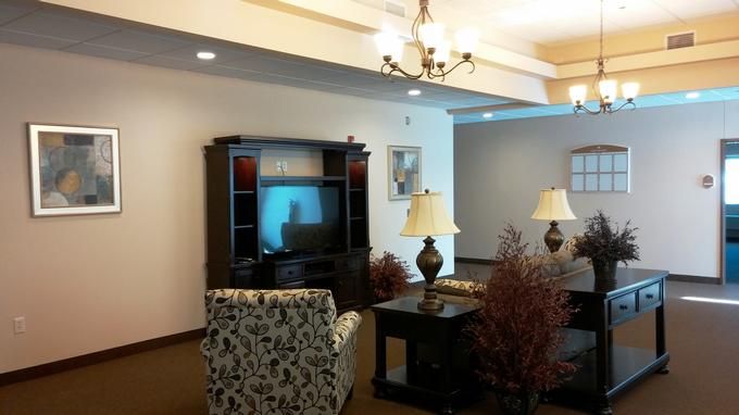 A cozy living room with classic furniture and a TV setup.