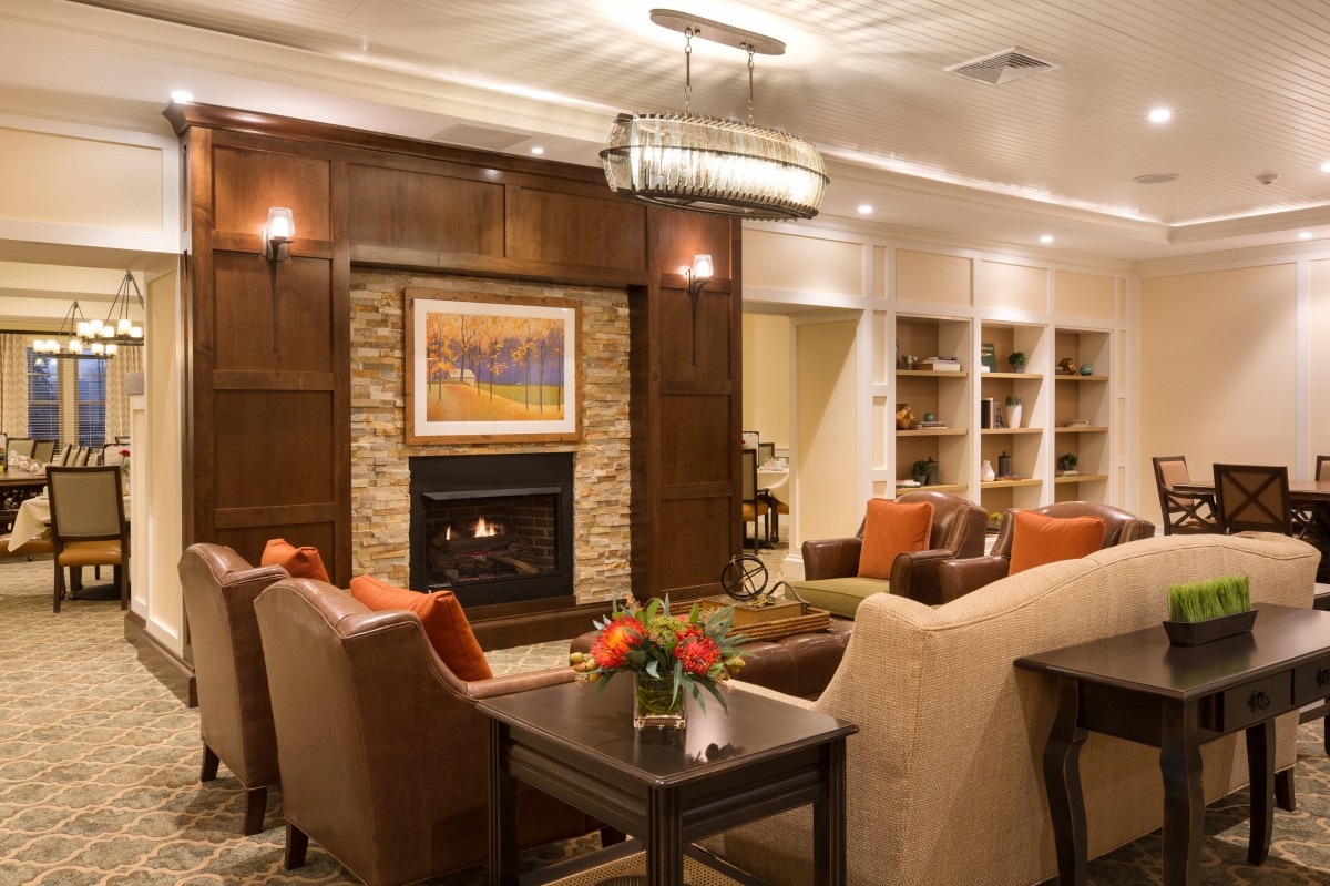 A cozy living room featuring a fireplace, modern decor, and comfortable seating.