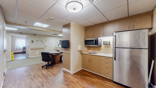 A well-equipped kitchenette area in a hospital room.