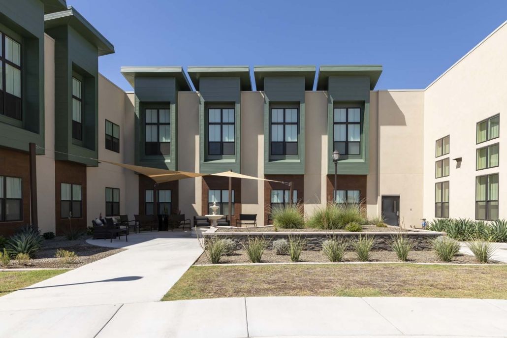 A modern apartment complex with contemporary architectural design and landscaped surroundings.