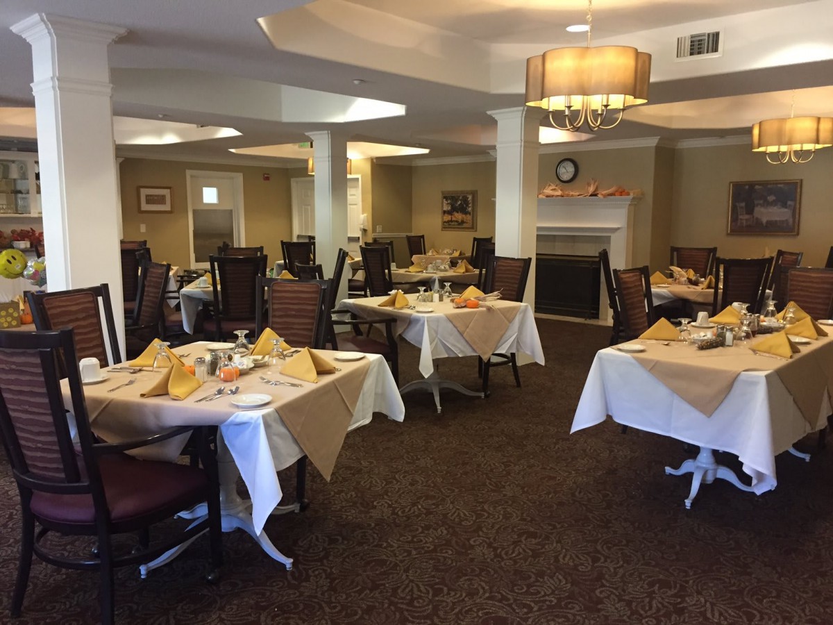 A cozy dining room set with tables and chairs, ready for guests.