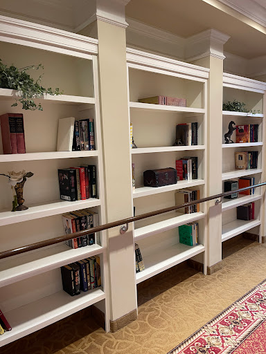A neatly arranged bookshelf showcasing a variety of books alongside decorative elements.