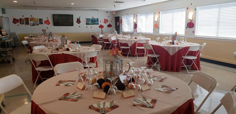 An elegantly decorated event hall with tables set for a gathering.