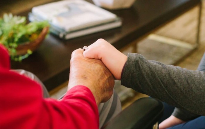 An image showing two people holding hands, symbolizing support and connection.