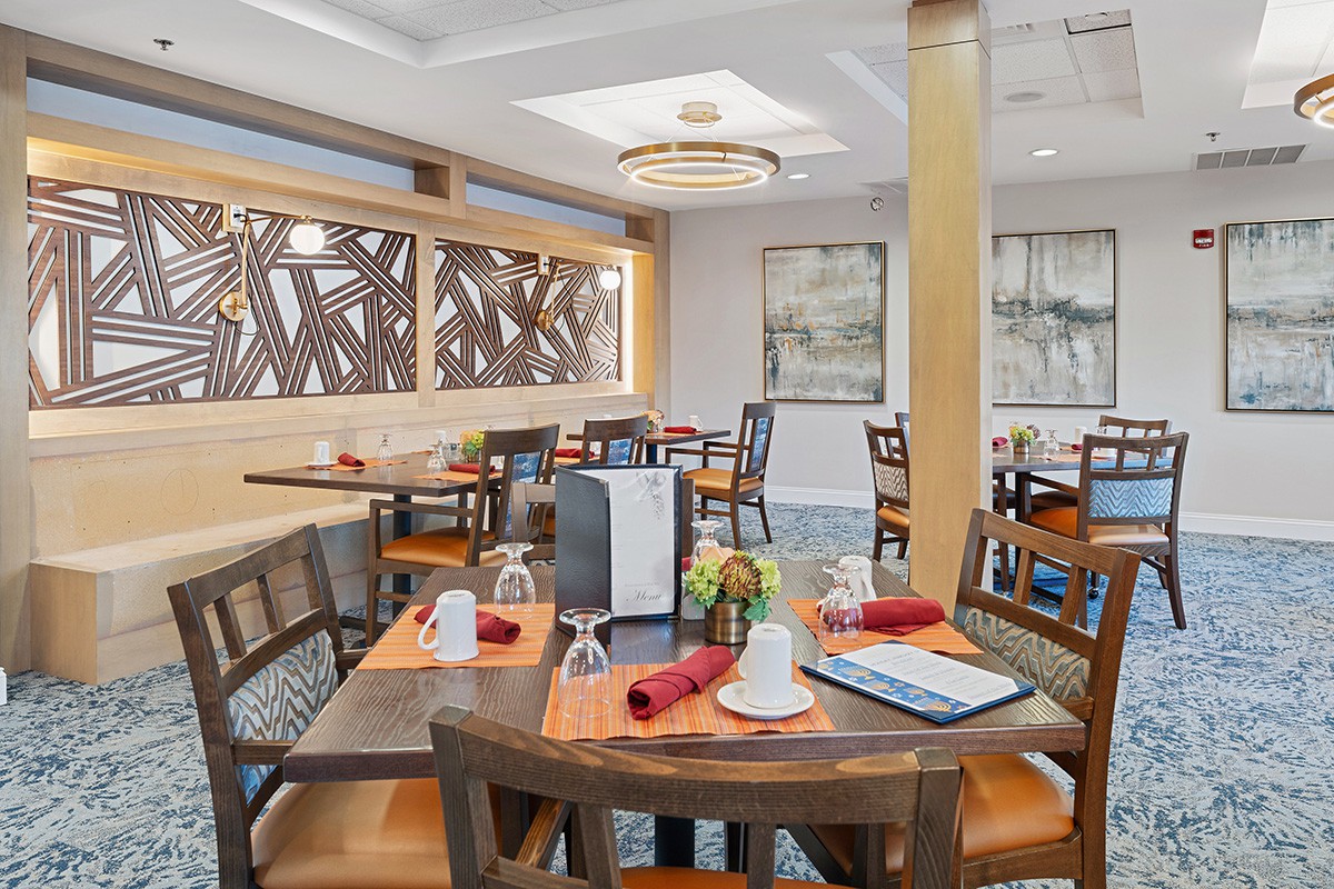 A modern restaurant dining area with neatly arranged tables and vibrant decor.
