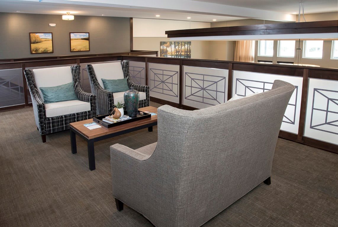 A modern interior seating area with comfortable sofas and a coffee table.