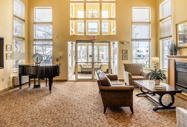 A spacious lobby with comfortable seating and a grand piano.