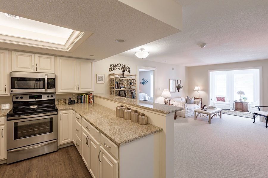 A modern kitchen with an open floor plan leading into a cozy living area.
