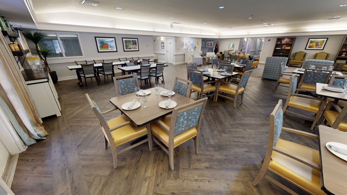 A well-decorated dining area with neatly arranged tables and chairs, ready for guests.