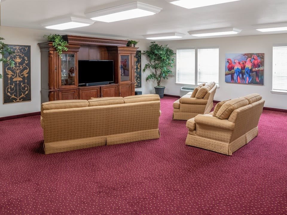 A spacious living room with comfortable seating and a large entertainment center.