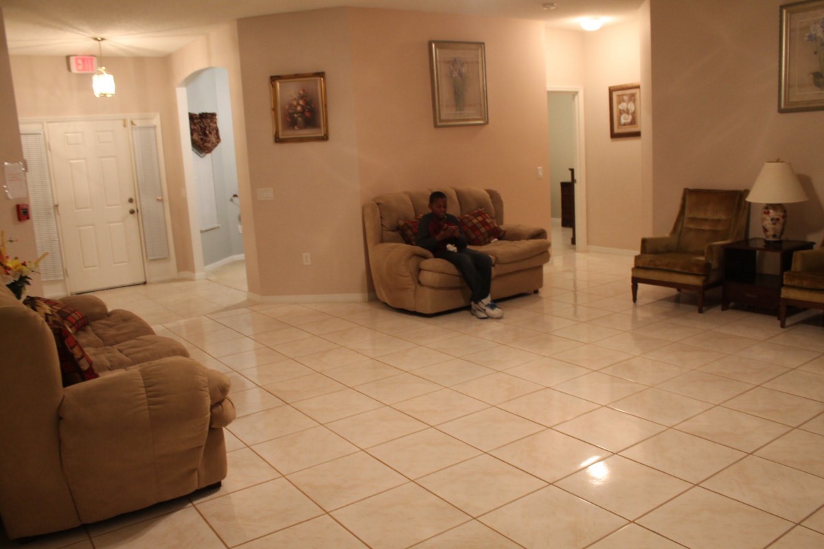 A cozy living room with tiled floors and comfortable seating.