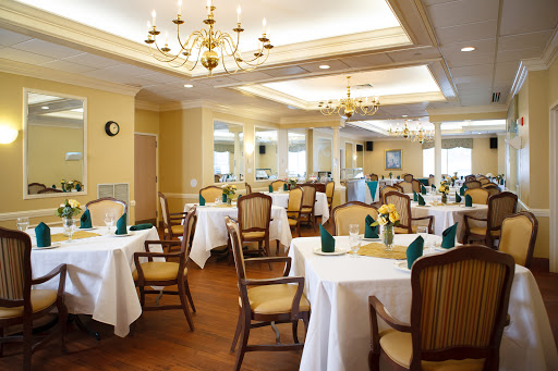 A beautifully arranged dining room featuring elegant tables and comfortable seating, perfect for formal gatherings.