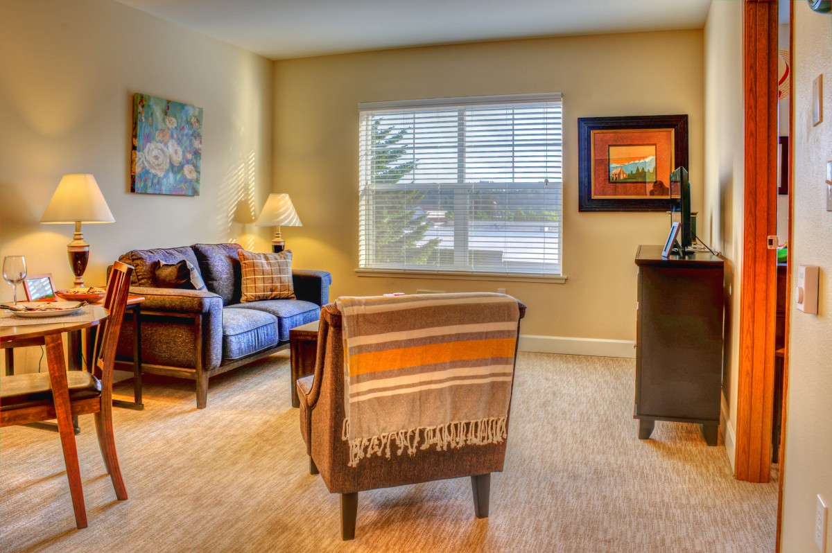 A cozy living room with comfortable seating and warm lighting.