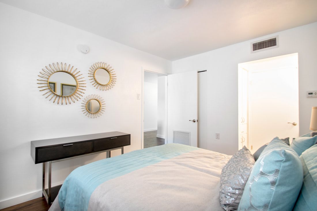 A modern, minimalist bedroom with white walls and elegant decor.