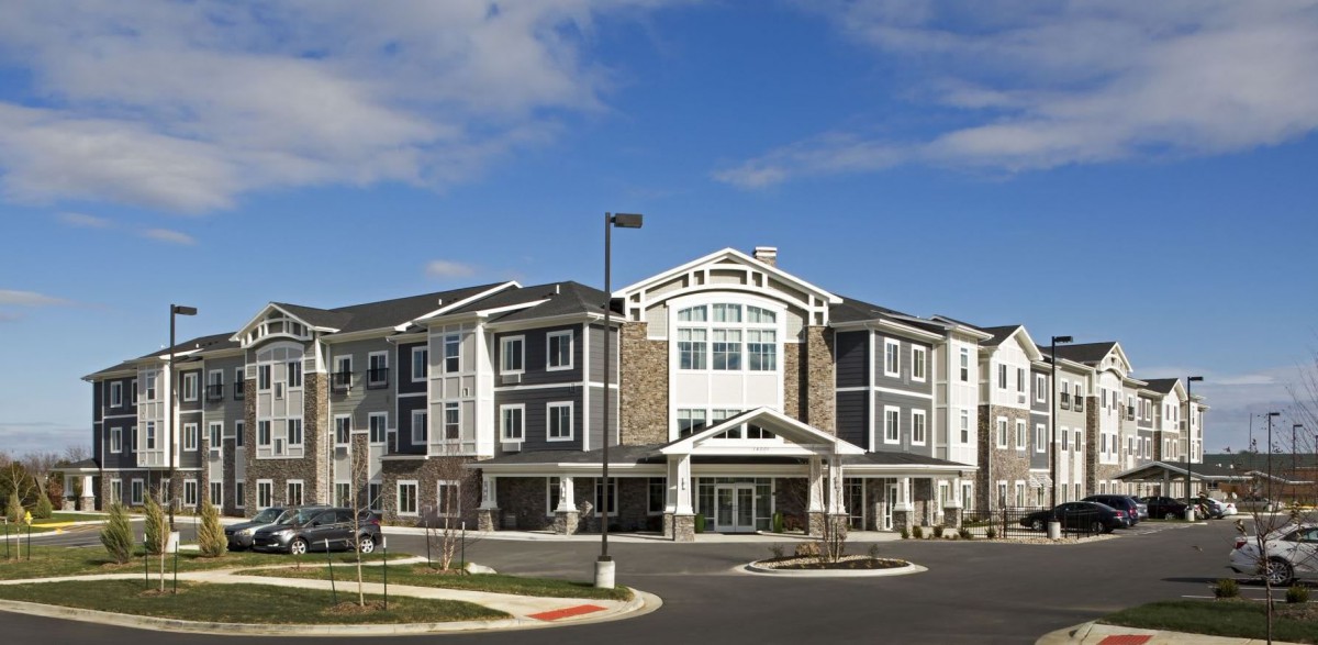 A modern hotel building with a stylish design under a clear blue sky.