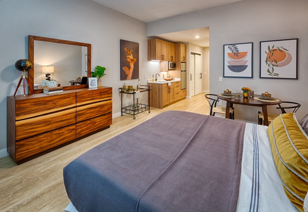 A modern and cozy bedroom featuring a comfortable bed, stylish furniture, and tasteful decor.