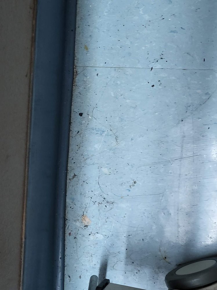 A close-up view of a window with visible textures and light reflections.