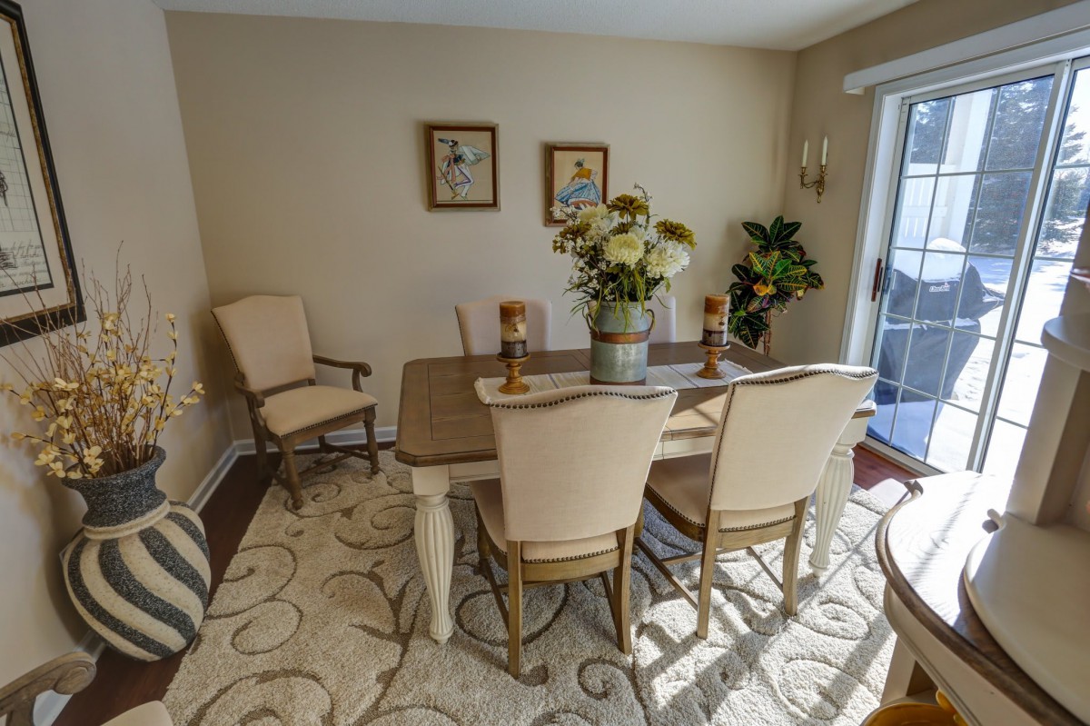 A cozy dining room with elegant furniture and decor.
