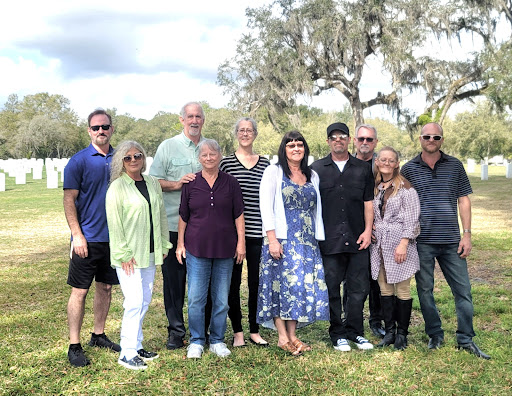 A cheerful gathering of friends and family enjoying a sunny day outdoors.