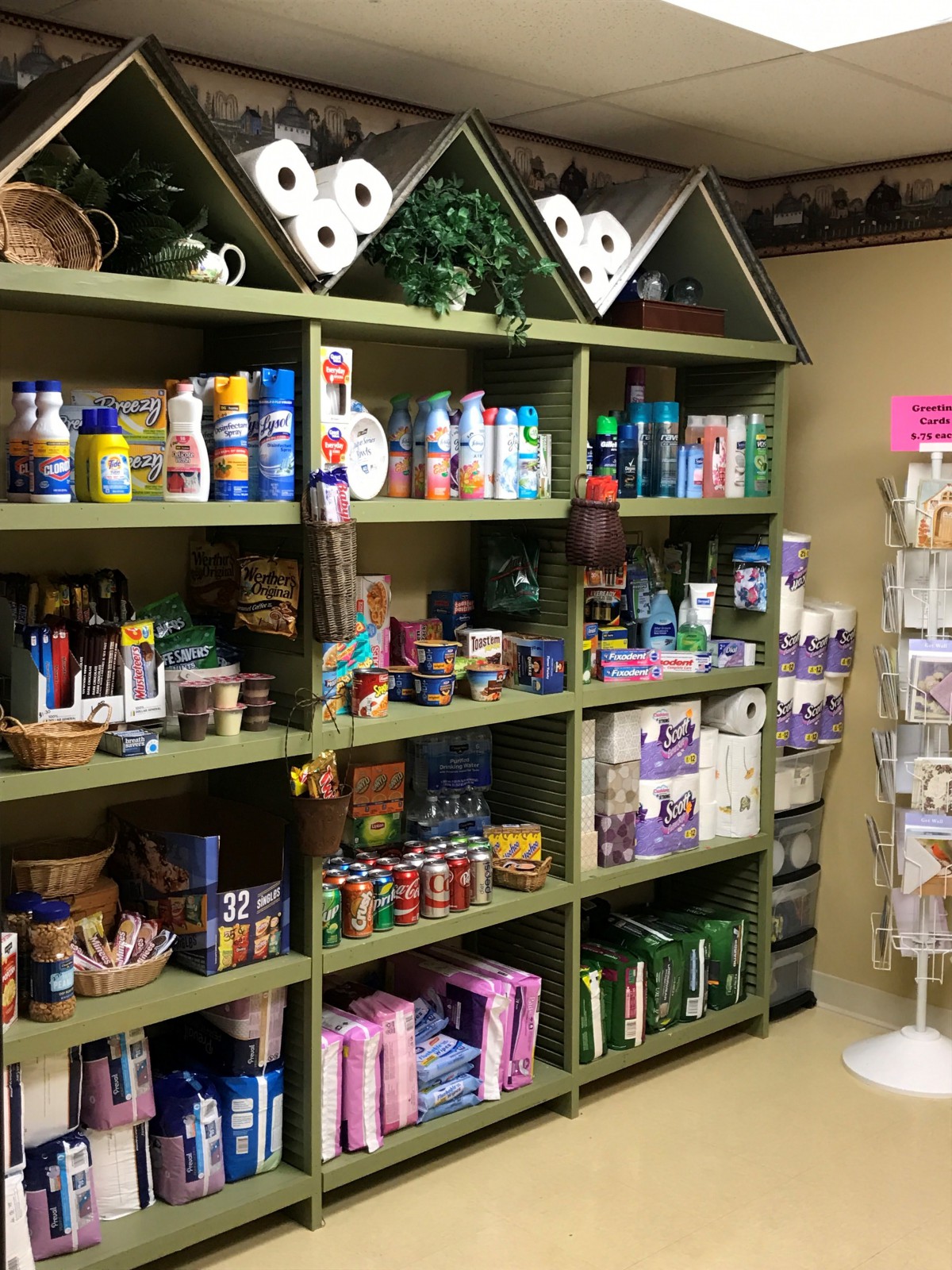 Shelves filled with various household and toiletry products in a small store.