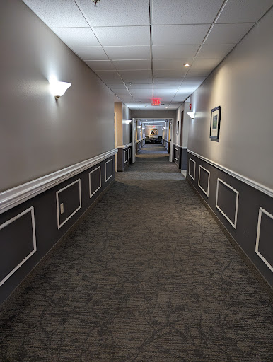 A well-lit hotel hallway showcasing a clean and modern design.