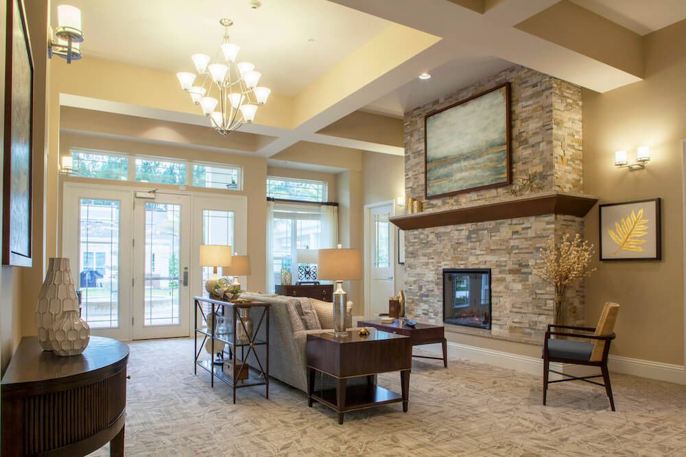 A modern living room with a stone fireplace and elegant decor.