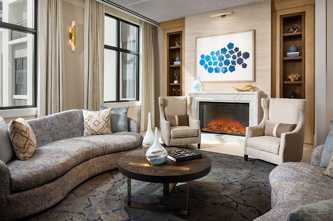 A stylish and cozy living room with a fireplace, featuring comfortable seating and modern decor.