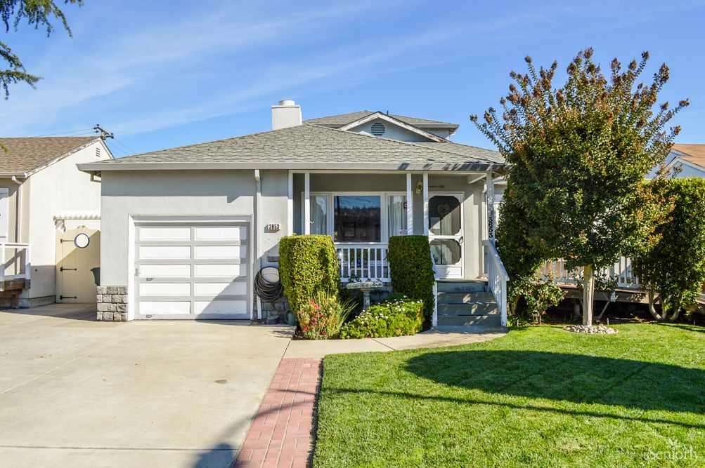 A suburban house with a well-maintained front yard and driveway.