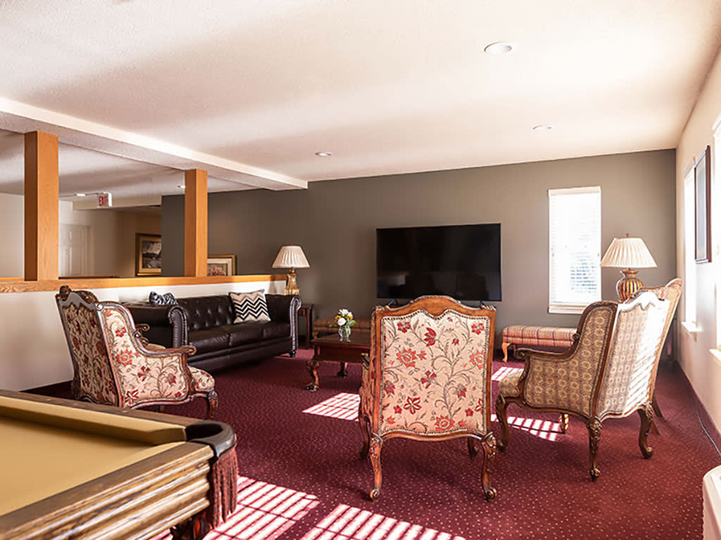 A cozy living room with elegant furniture and a large television.
