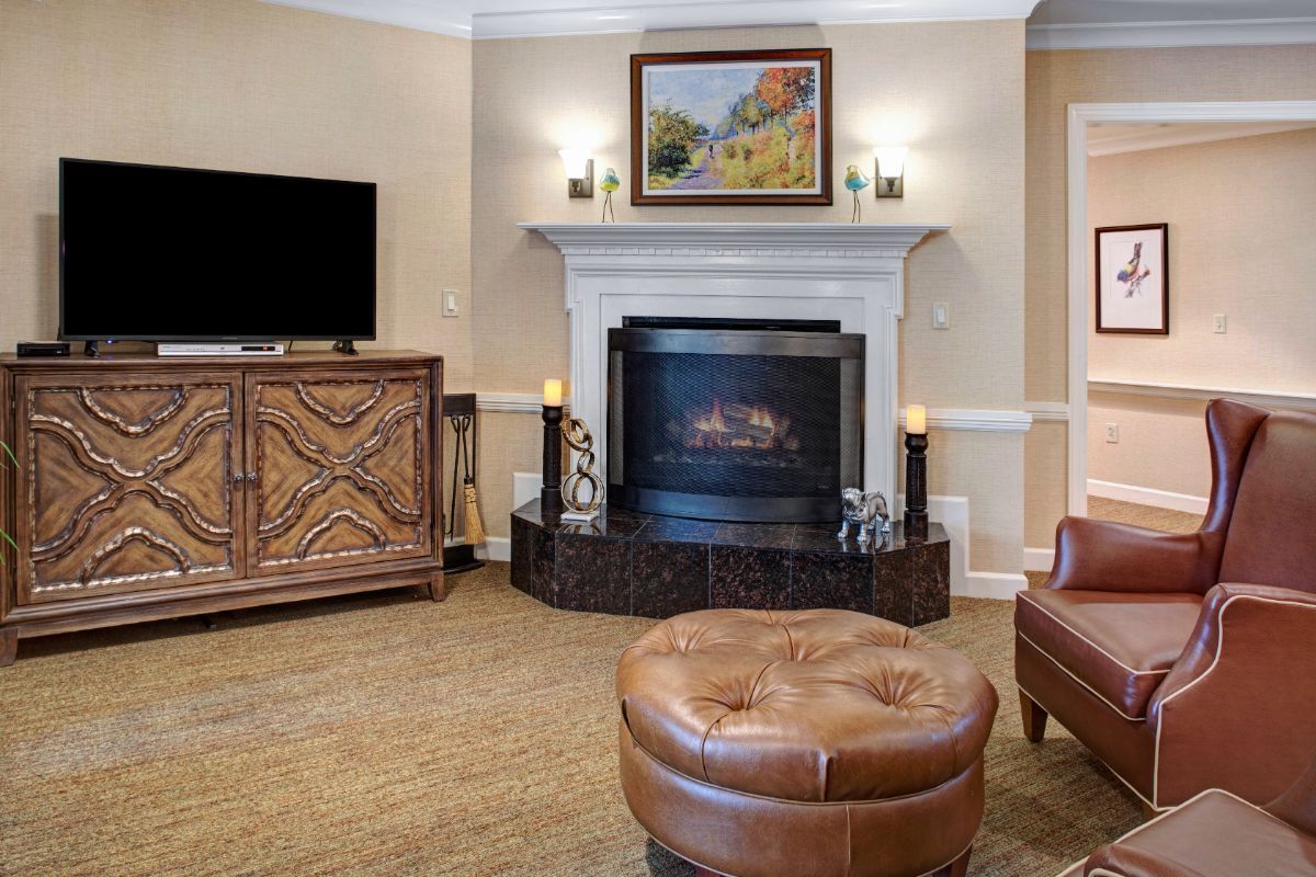 A cozy living room featuring a fireplace, comfortable seating, and decorative accents.