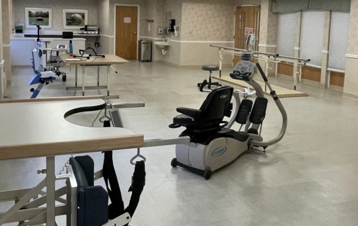 A rehabilitation room equipped with exercise and therapy equipment.