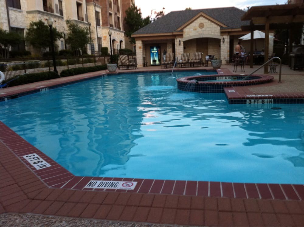 A serene outdoor swimming pool adjacent to residential buildings.