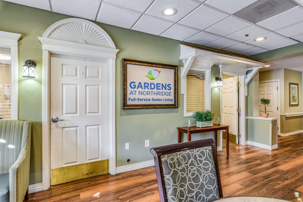 Reception area with signage and furniture in a professional setting.