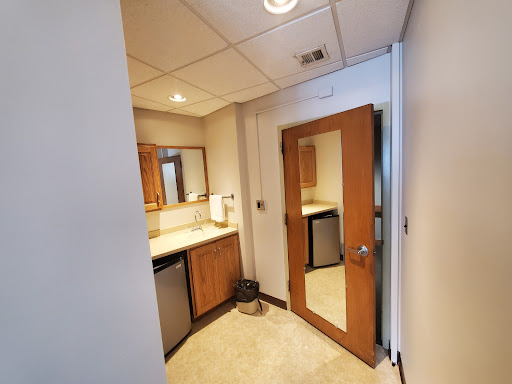 A well-lit bathroom featuring wooden cabinetry and a contemporary design.