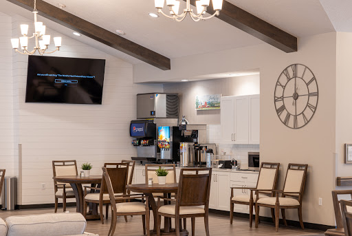 A modern dining area featuring stylish furniture and a cozy coffee station.