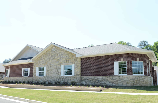 A modern residential building with a combination of stone and brick exterior.
