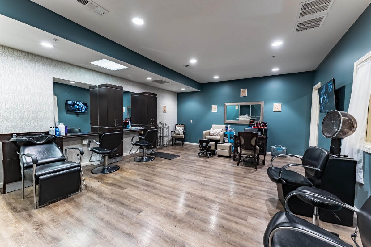 Modern salon interior with styling chairs and mirrors.