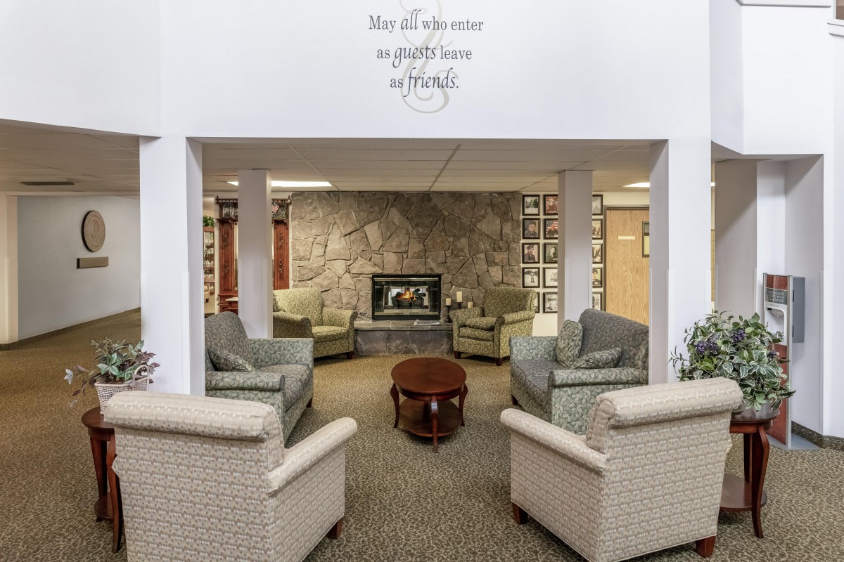 A cozy living room with comfortable seating and a stone fireplace.