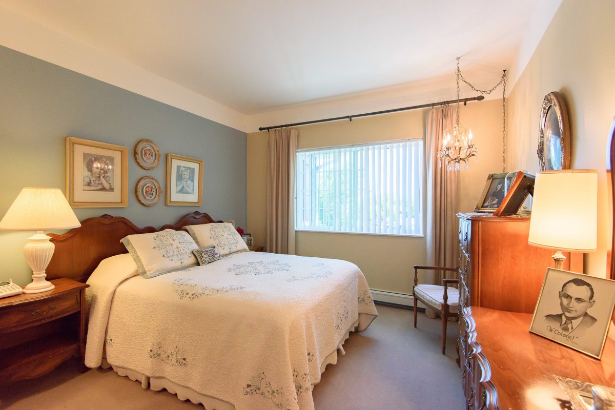 A cozy bedroom with elegant decor and a large bed near a window.