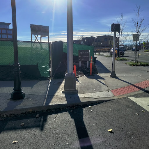 A sunny day on a construction site with visible street infrastructure.