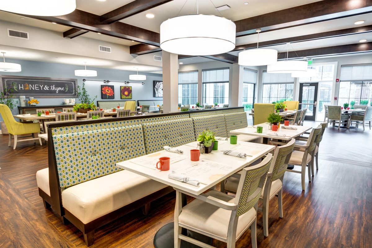 A modern dining area with stylish furniture and lighting.