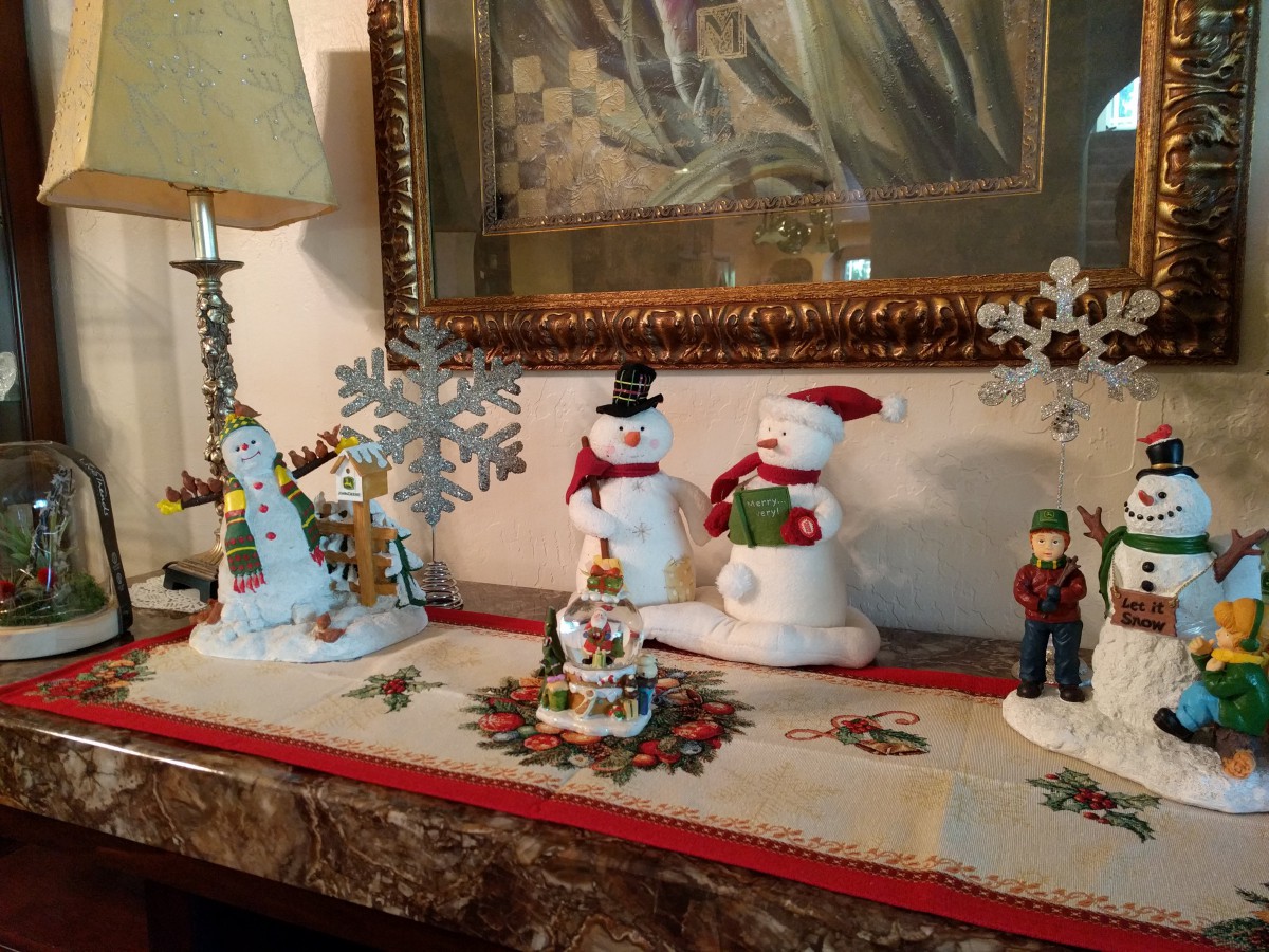 A festive indoor display featuring Christmas decorations with snowmen and holiday ornaments.