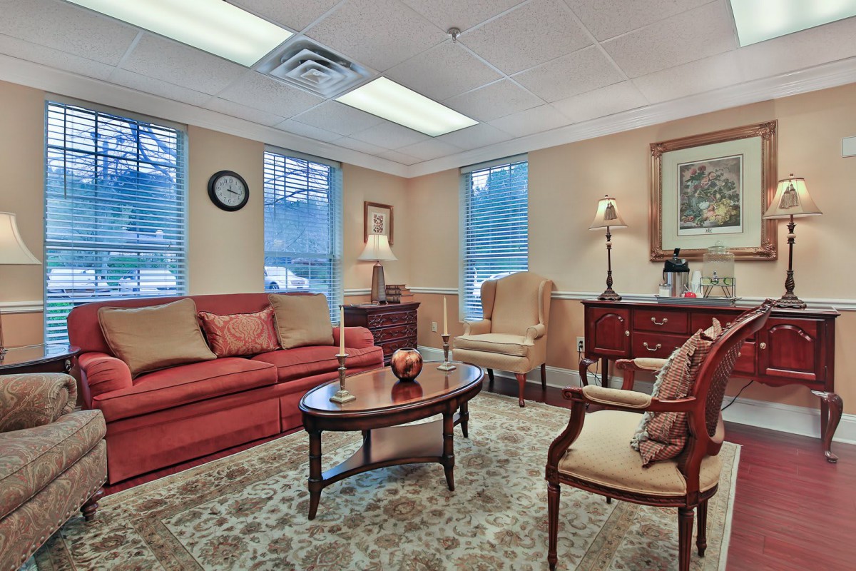A cozy and elegantly furnished living room with a sofa, armchairs, and coffee table.