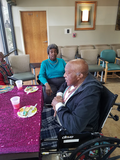 A warm community gathering for seniors, featuring food and cheerful conversations.