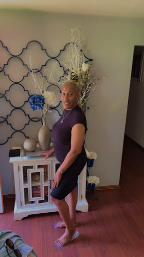 A woman posing gracefully in a beautifully decorated indoor space.