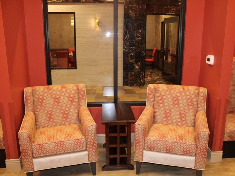 A cozy indoor seating area with two patterned armchairs and a small side table.