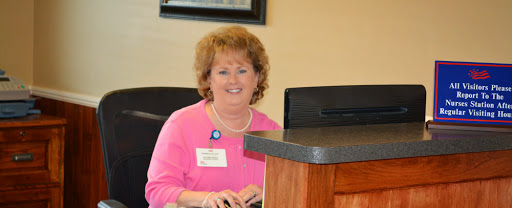 A friendly receptionist at her desk, ready to assist visitors.