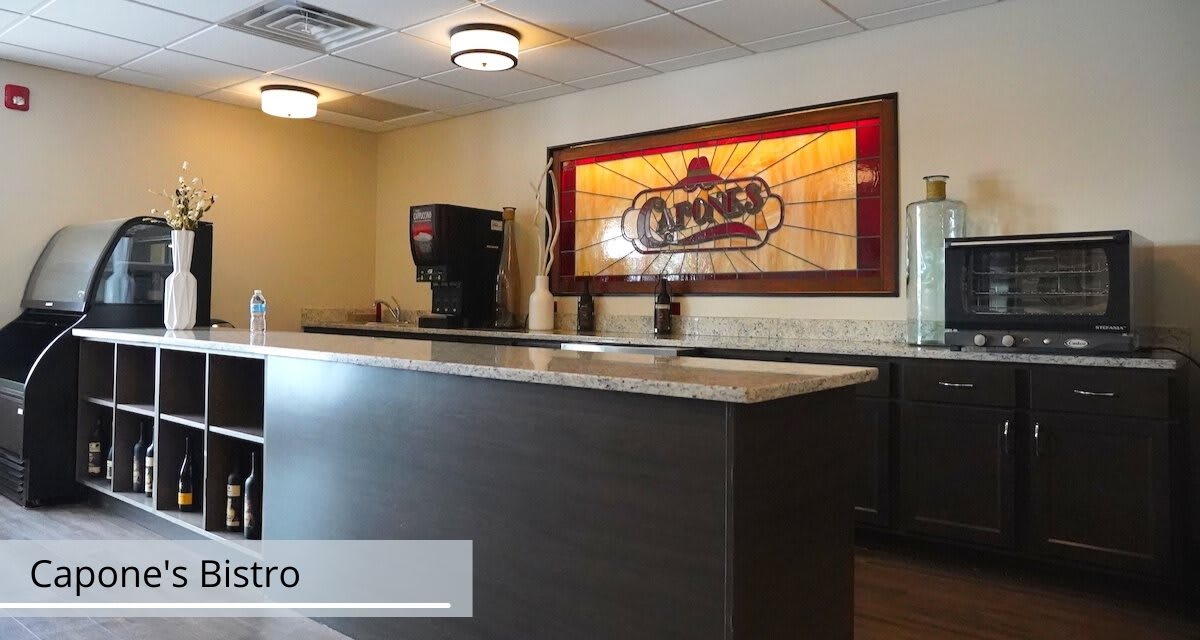 A hotel reception area featuring a counter and decorative lighting.