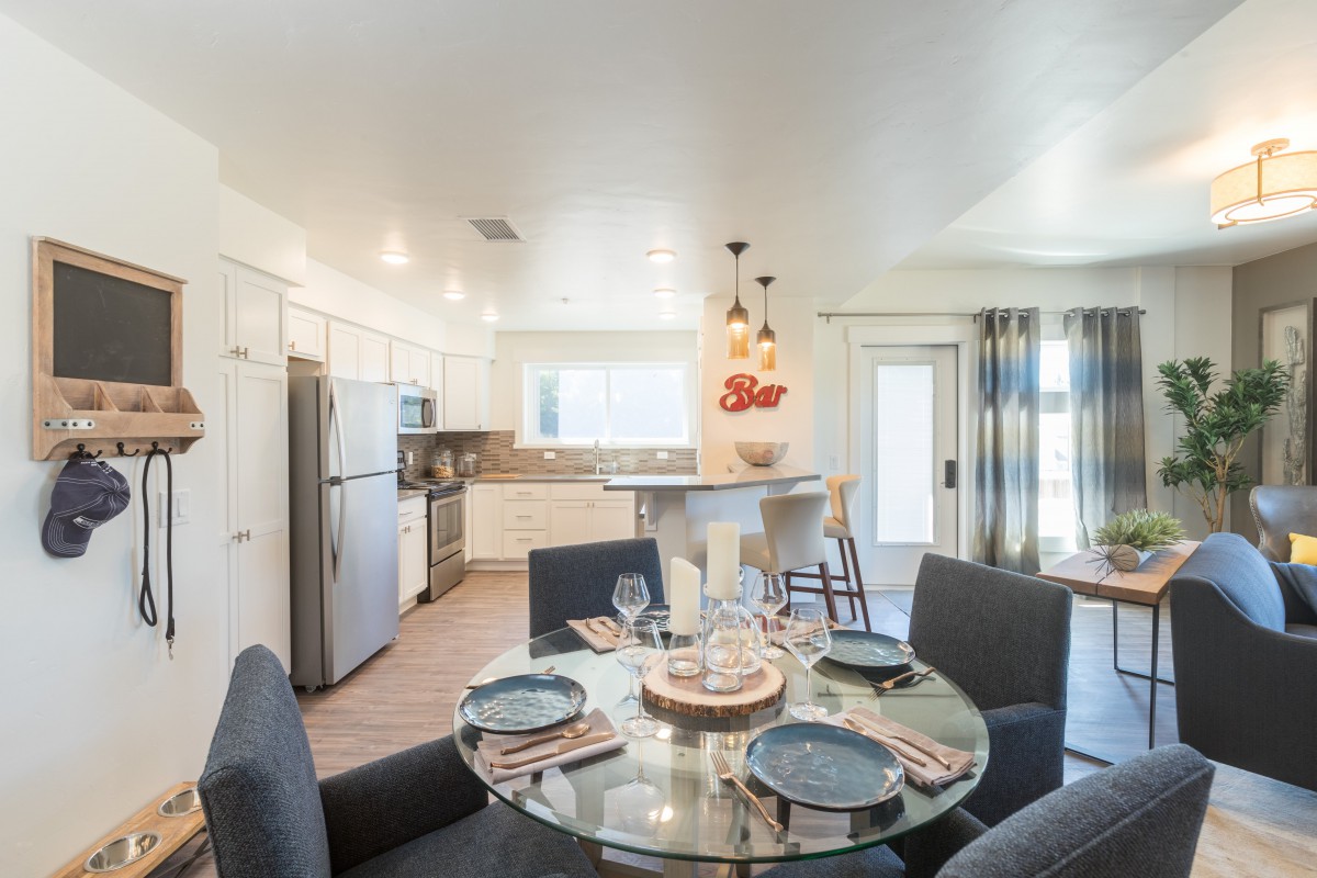 A modern open-concept kitchen and dining area with stylish furnishings and decor.