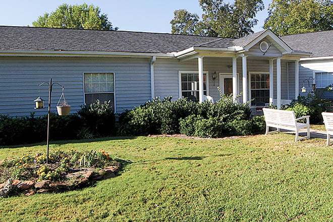 A suburban house with a well-maintained lawn and garden.